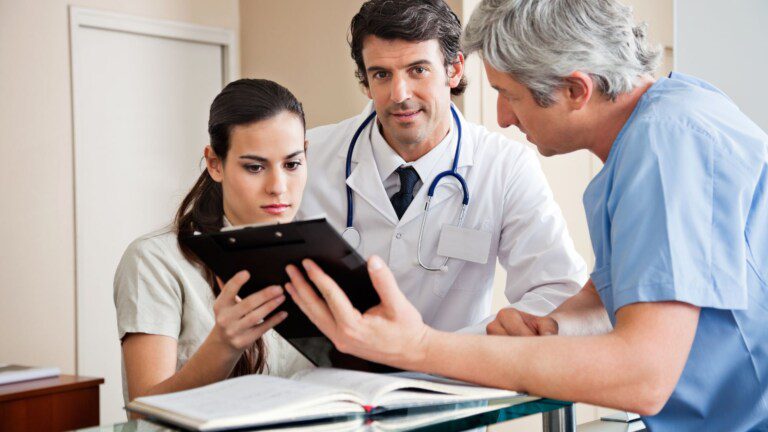 Healthcare practitioners explaining a chart to a patient